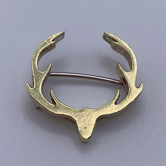Stag antlers badge in brass